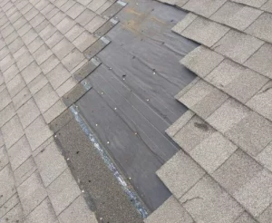 residential roof with missing shingles in Blue Springs