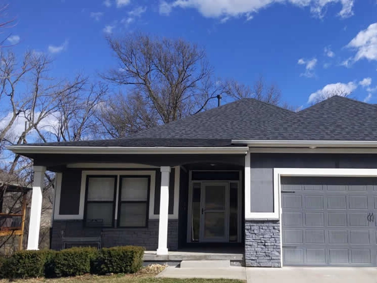 Grey Homer With New Asphalt Roof