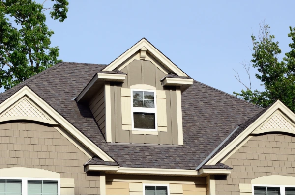 Residential home with HOA-approved brown architectural shingles and coordinated exterior colors