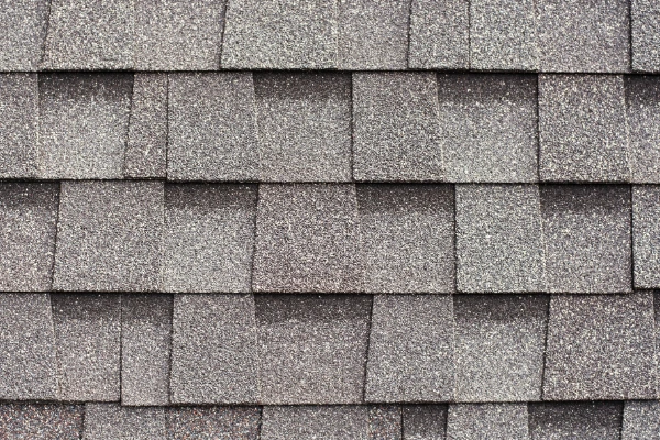 Light gray architectural shingles with tones and shadows giving them dimension.